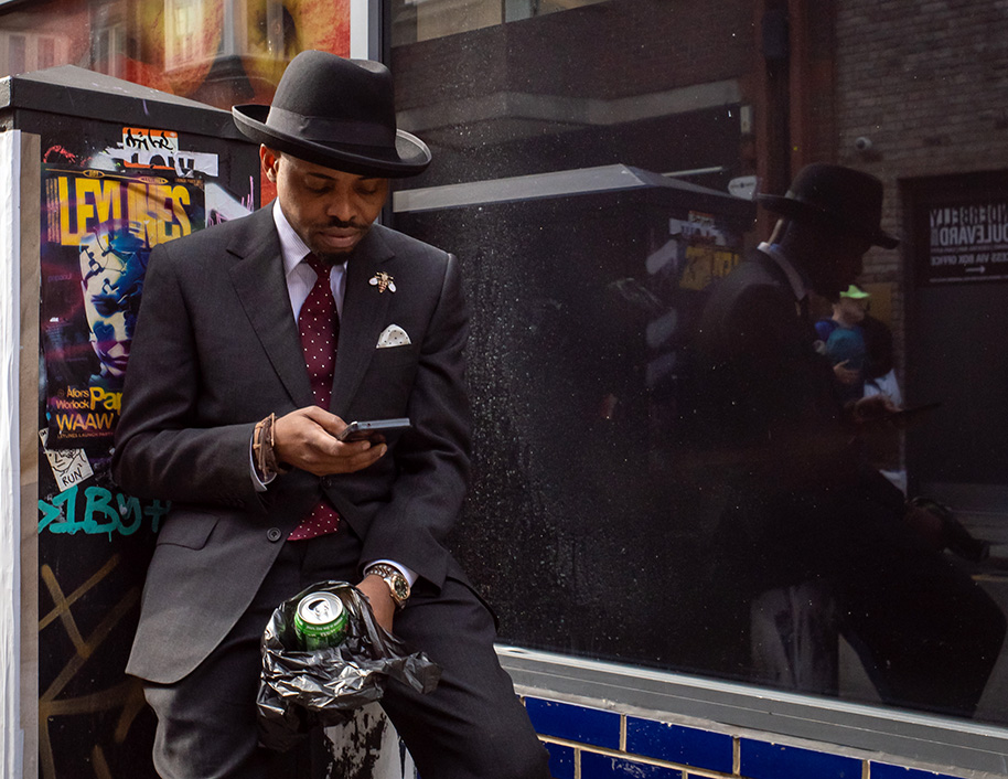 Stylish man in suit and hat in Soho, London, UK.