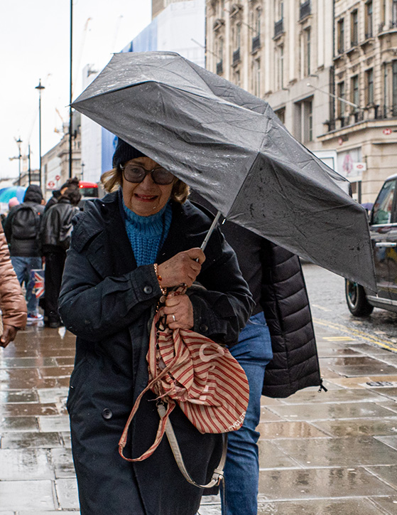 Woman under umbrella, Oxford Street, London.