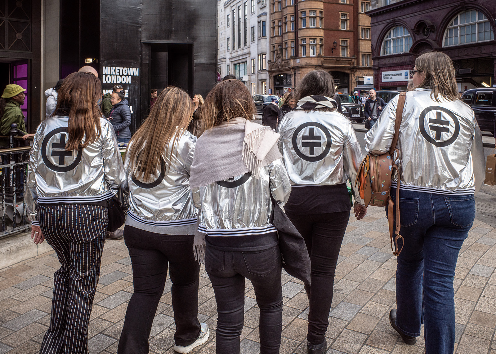 Five Take That fans with matching TT jackets at Oxford Circus, London, UK.